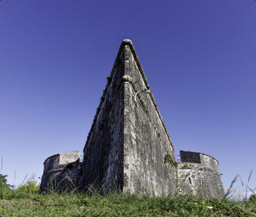 The bow-shaped stone walls of Fort Fincastle against a deep blue sky.