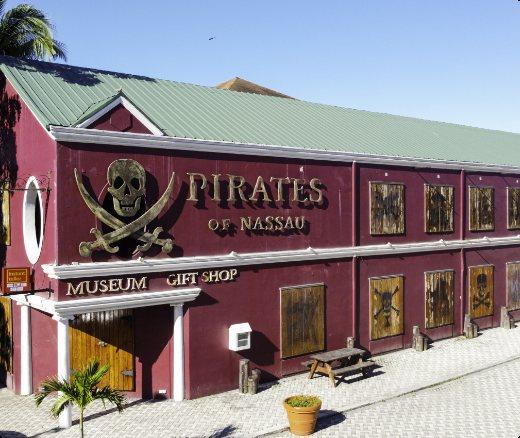 The maroon Pirates of Nassau museum building with a skull-and-crossbones sign.