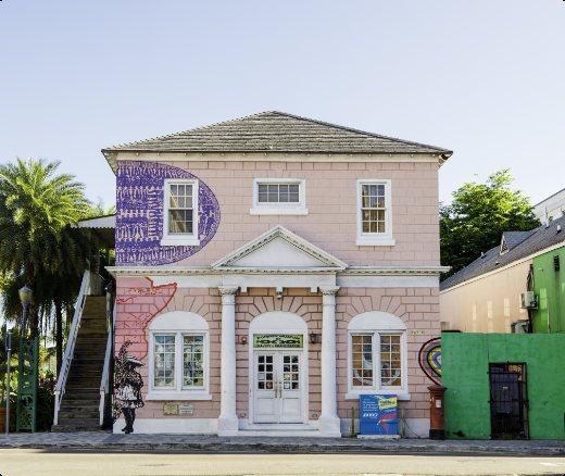 The pink two-storey Pompey Museum building with a painted mural.